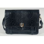 A 1950's - 1960's BLACK CROCODILE SKIN HANDBAG with iron numbers and long extending crocodile skin