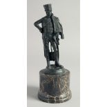 A BRONZE FIGURE AS A HUSSAR. 7ins on a marble plinth.