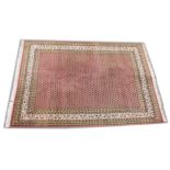 A PERSIAN DESIGN CARPET, pink ground with all over "Boteh" design. 7ft 10ins x 5ft 7ins.