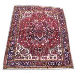 A PERSIAN DESIGN CARPET, red ground with stylised decoration. 10ft x 8ft.