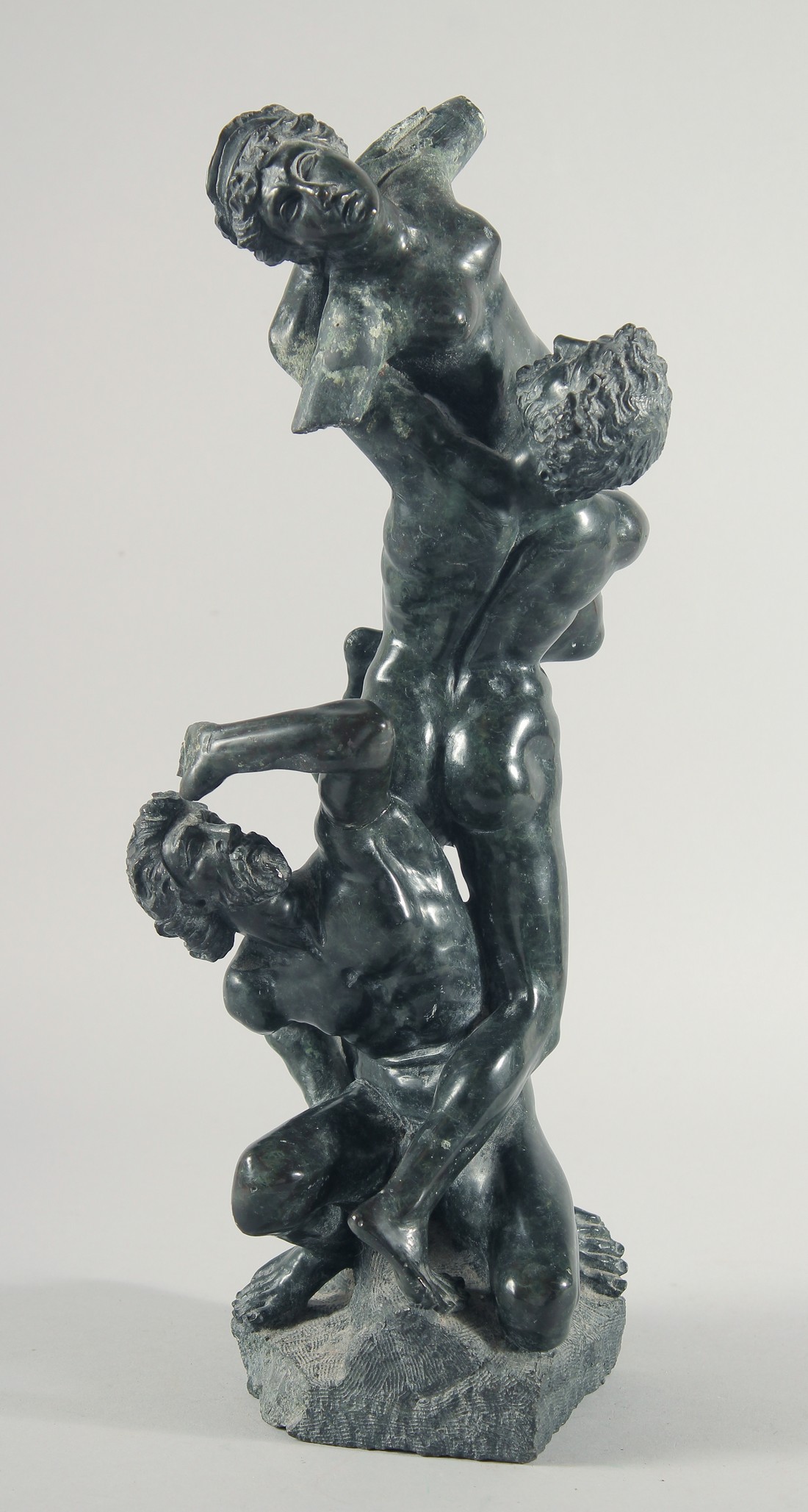 A 19TH CENTURY CARVED SERPENTINE CLASSICAL GROUP. "The rape of the Sabines" 16ins high.