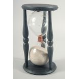 A LARGE WOODEN SAND TIMER. 8ins high.
