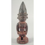 A GOOD CARVED WOOD YORUBA STAND UP FIGURE. 10.5ins high.