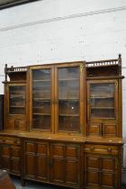 A GOOD VICTORIAN AESTHETIC MOVEMENT OAK BREAK FRONT LIBRARY CUPBOARD BOOKCASE with ornate brass