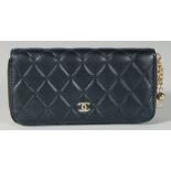 A CHANEL BLACK QUILTED PURSE. 7ins long, 3.5ins deep.