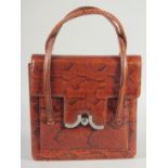 A 1940's - 1950's SNAKESKIN HANDBAG with chrome lock, fitted leather interior with a purse, complete