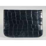 A 1940's - 1950's BLACK PATENT CROCODILE SKIN CLUTCH BAG with fold over flap and fitted interior.
