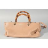 A LIMITED EDITION GUCCI TAN LEATHER BAG with two bamboo handles and long leather strap. 13ins