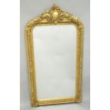 A LARGE DECORATIVE OVER MANTLE MIRROR.