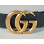 A LONG BLACK LEATHER GUCCI BELT.