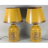 A PAIR OF CHINESE DESIGN YELLOW TOLEWARE LAMPS AND SHADES. 28ins high including shades.