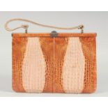 A 1940's - 1950's TWO COLOUR CROCODILE SKIN HANDBAG with raised skin, iron mount, fitted interior
