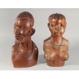 A PAIR OF CARVED WOOD AFRICAN BUSTS.