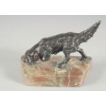 A SMALL BRONZE RETRIEVER on a marble base. 4.5ins long.