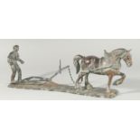 A BRONZE GROUP. A MAN PLOUGHING with a horse. 18ins long.