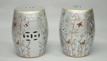 A PAIR OF CHINESE STYLE BARREL SEATS decorated with butterflies. 1ft 5ins high.