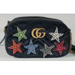 A GUCCI LIMITED EDITION BLACK VELVET BAG with six coloured stars with long leather strap. No. 467632