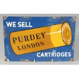 AN ENAMEL SIGN which reads ‘WE SELL PURDEY LONDON CARTRIDGES’ on a shotgun shell. 12ins x 8ins.