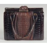 A 1940 - 1950 BLACK AND BROWN CROCODILE SKIN HANDBAG with a strip of brown crocodile skin on a black