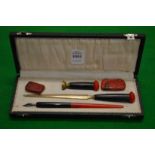 A cased writing set.