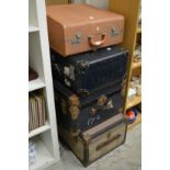 Four large suitcases/trunks.