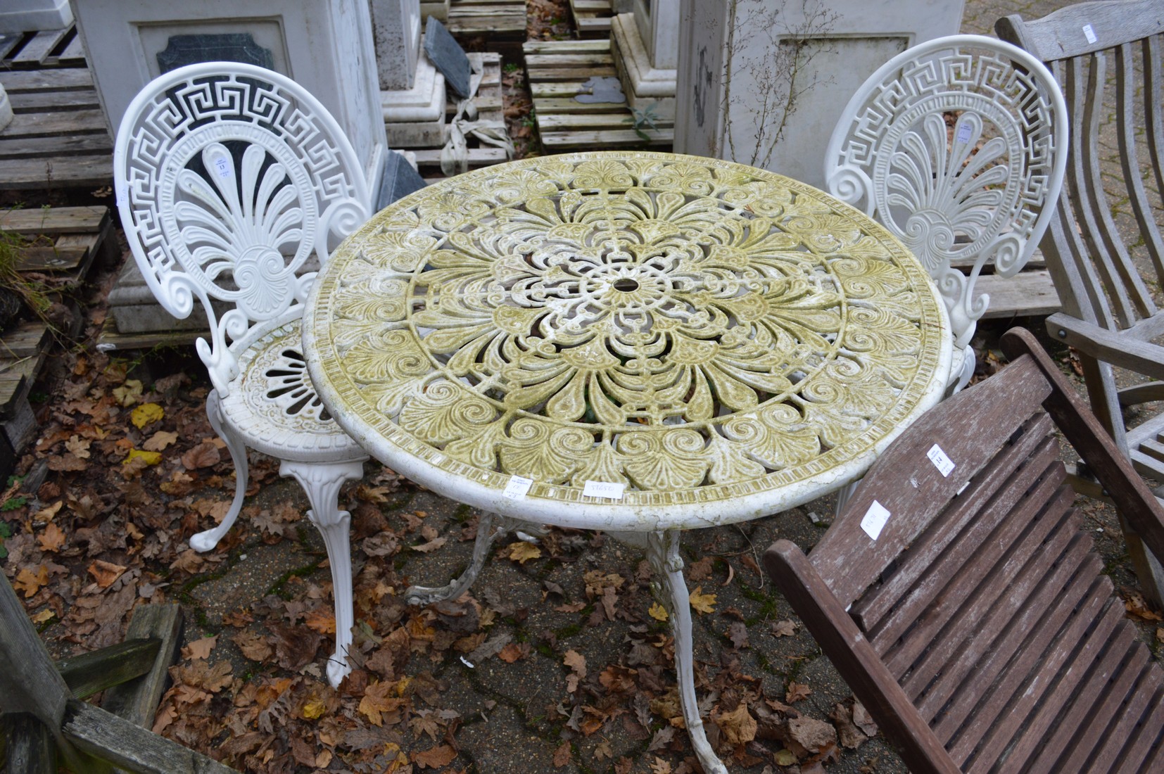 An aluminium circular patio table and pair of chairs.
