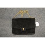 A ladies black velvet evening bag.