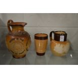 Doulton salt glazed items to include a 1902 Coronation jug, a hunting beaker and a Commemorative jug