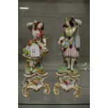 A good pair of Paris porcelain figures of young ladies with bunches of grapes.