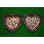 A pair of cast silver heart shaped dishes.