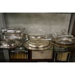 A collection of plated entree dishes and covers.