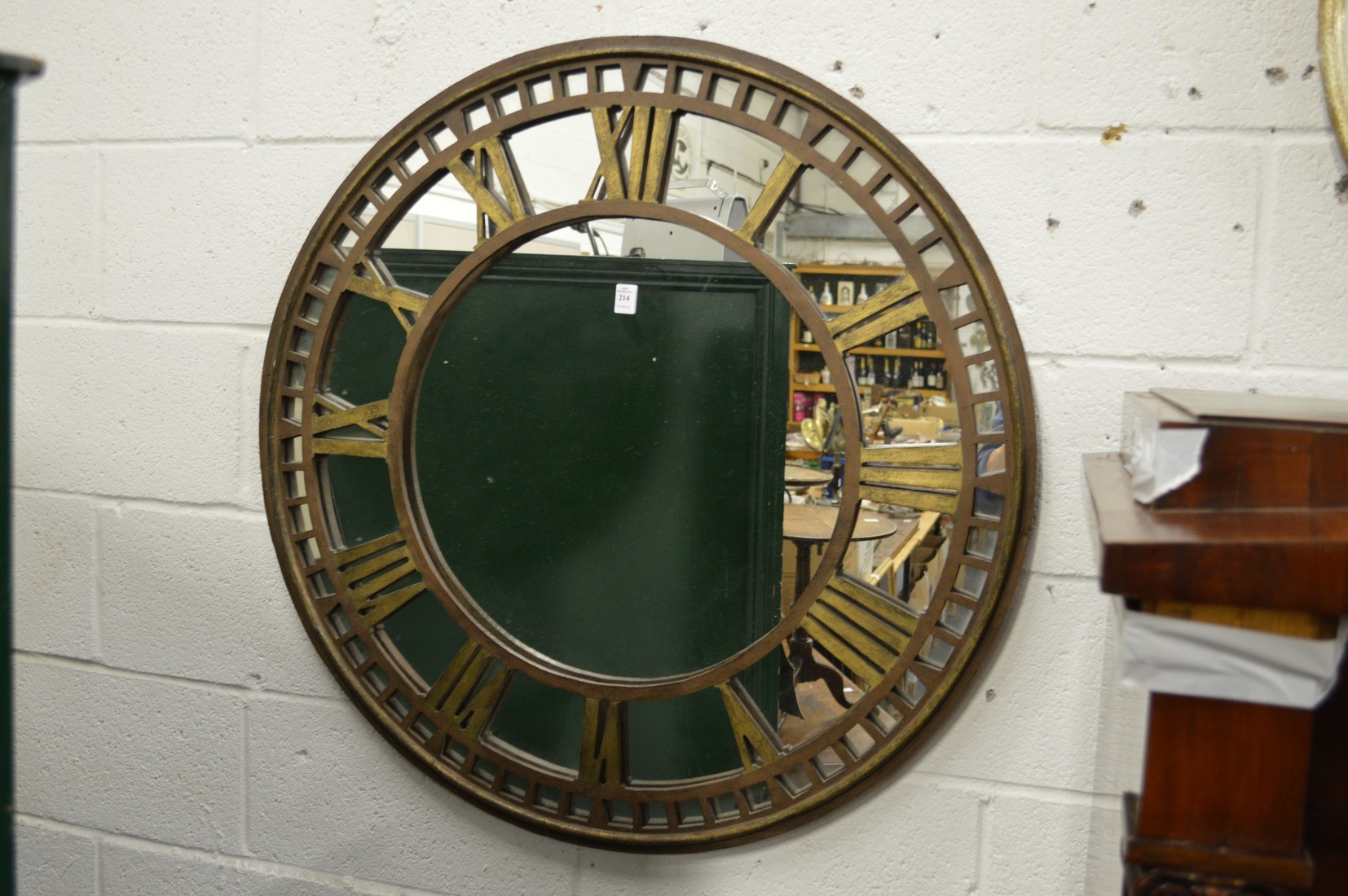 A metal clock face circular mirror.