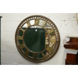 A metal clock face circular mirror.