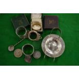A group of small silver items.