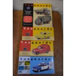 A group of four Vanguards models of police car and other vehicles, all boxed.