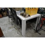 A modern white lacquer table and six dining chairs.