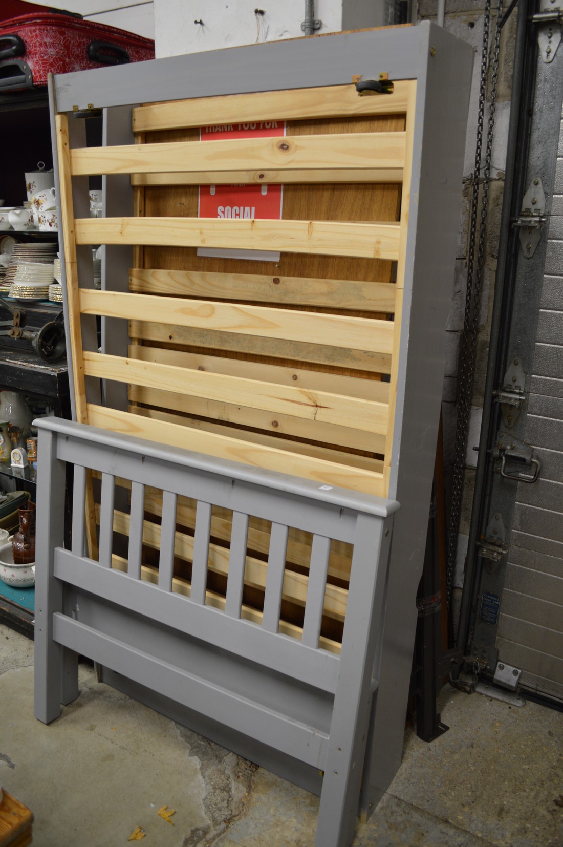 A grey painted pine trundle bedframe.