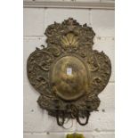 Continental embossed metal wall applique.