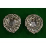 A pair of pierced silver heart shaped bonbon dishes.