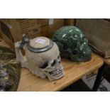 An unusual skull shaped tankard and a carved hard stone model of a skull.