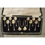 A cased set of twelve silver coffee spoons and sugar tongs.