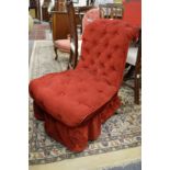 A Victorian button upholstered nursing chair upholstered in a red velveteen fabric.