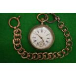 A pocket watch with gilt metal chain.