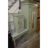 Decoratively painted part bedroom suite comprising wardrobe, pot cupboard, table, and towel rail.