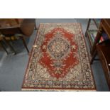 A Persian style rug, red ground with floral decoration 190cm x 120cm.