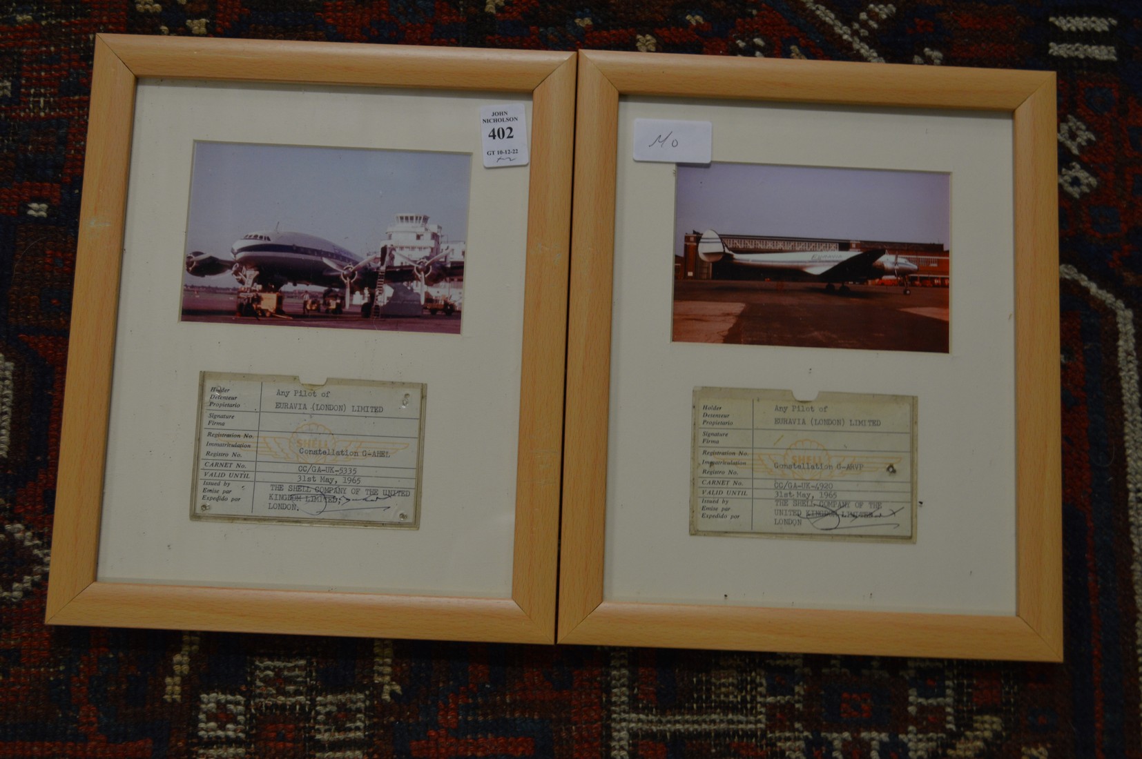 A pair of photographic prints of aircraft complete with Shell oil company pilot boarding pass framed