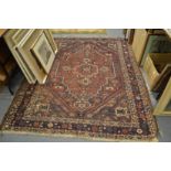 A Persian Shiraz carpet with stylised decoration 200cm x 170cm.