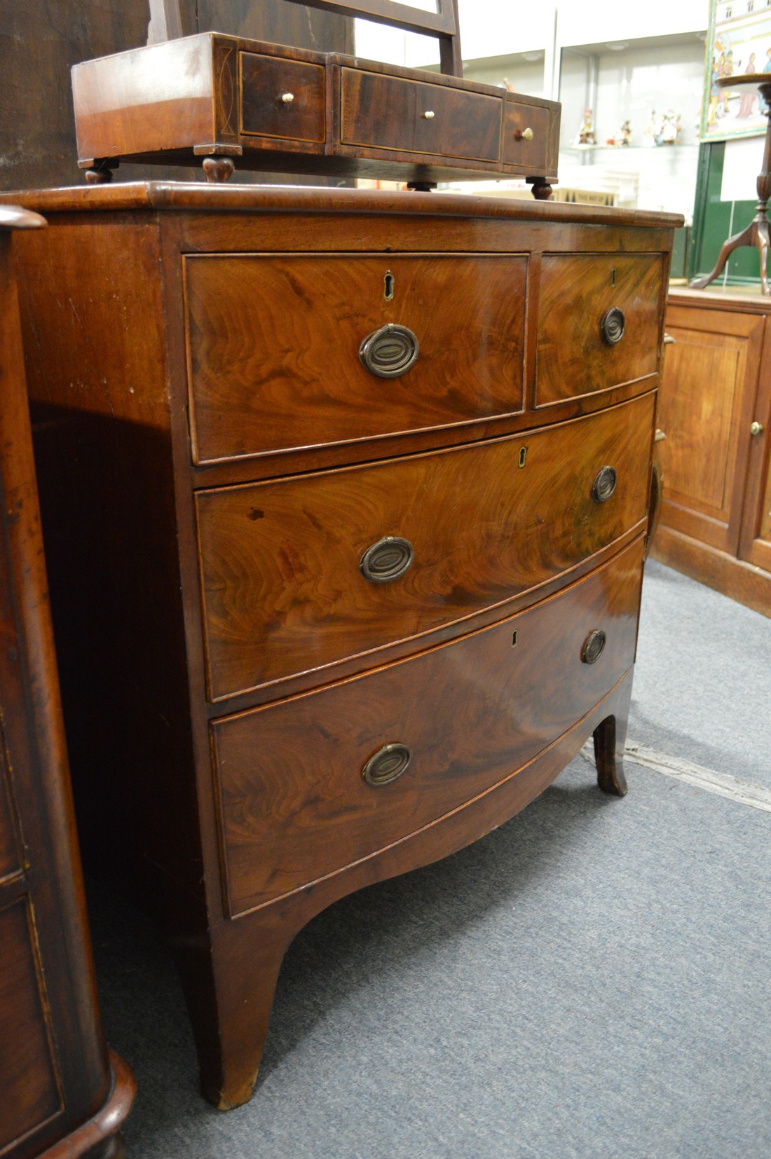 A 19th century mahogany bow front chest of two short and two long drawers on bracket feet.