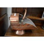 A copper coal scuttle.