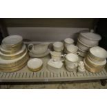 Gilt decorated white porcelain dinnerware, various makers.